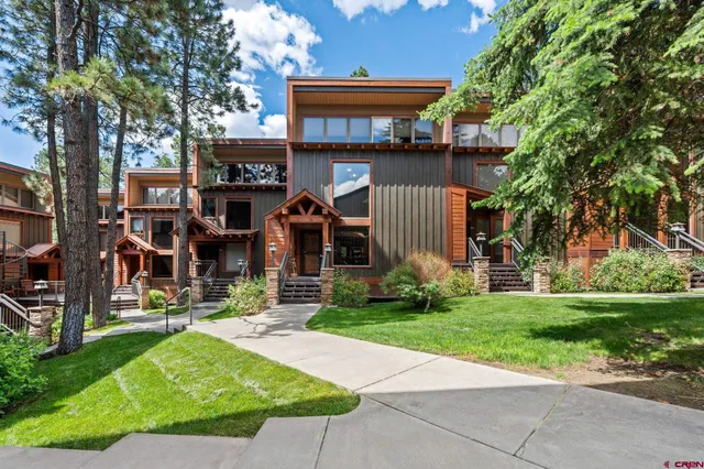 a green field with lots of trees in it