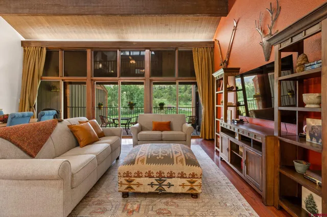 a living room with furniture lamp and large window