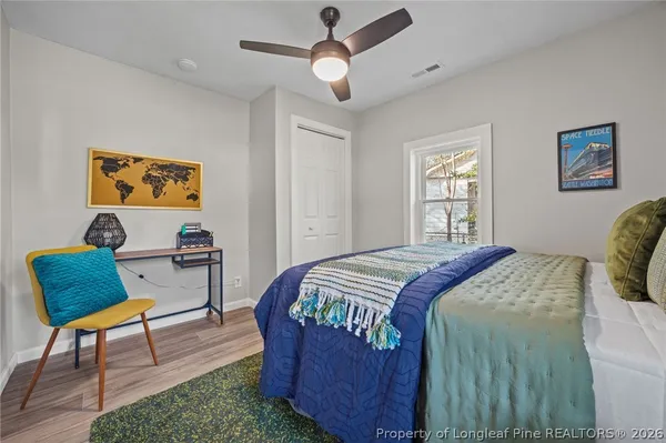 a bedroom that has a bed and a chair in it