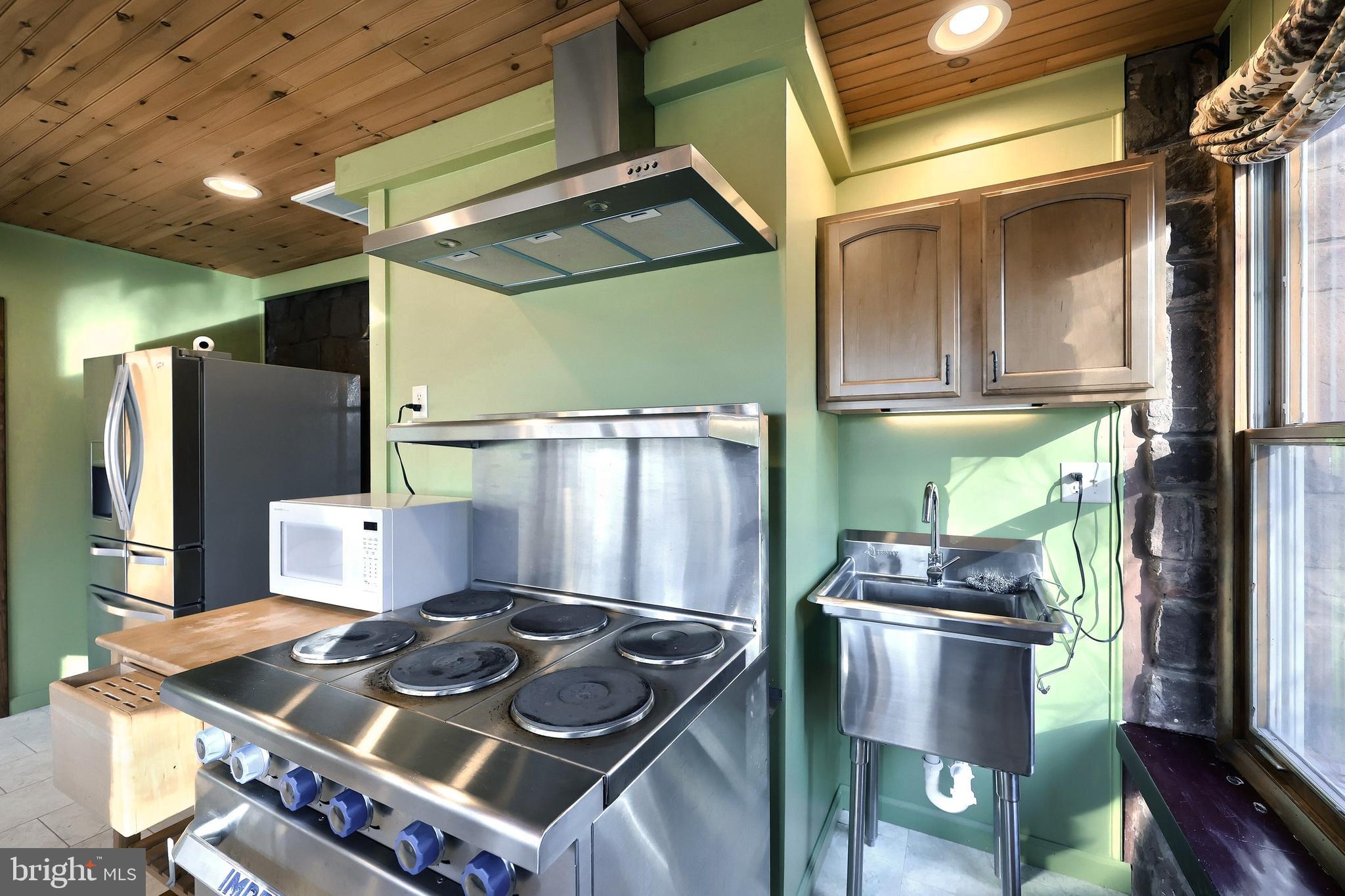 6691 Harmony Grove Road Dover, PA 17315 - Photo 13 of 66 a kitchen with stainless steel appliances granite countertop a stove and a refrigerator