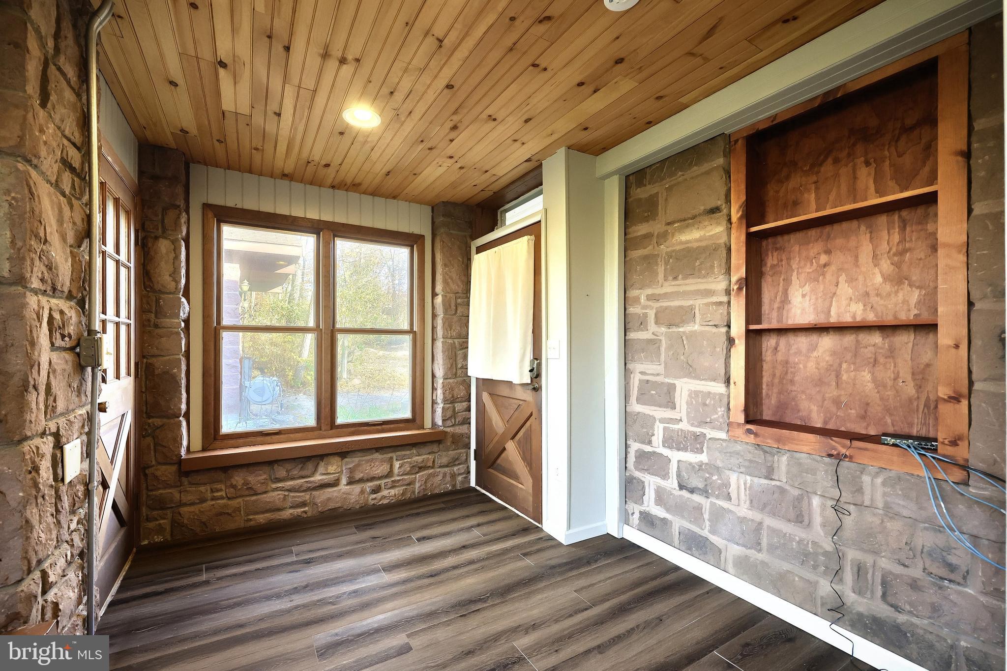 6691 Harmony Grove Road Dover, PA 17315 - Photo 26 of 66 a view of an empty room with a window and wooden floor
