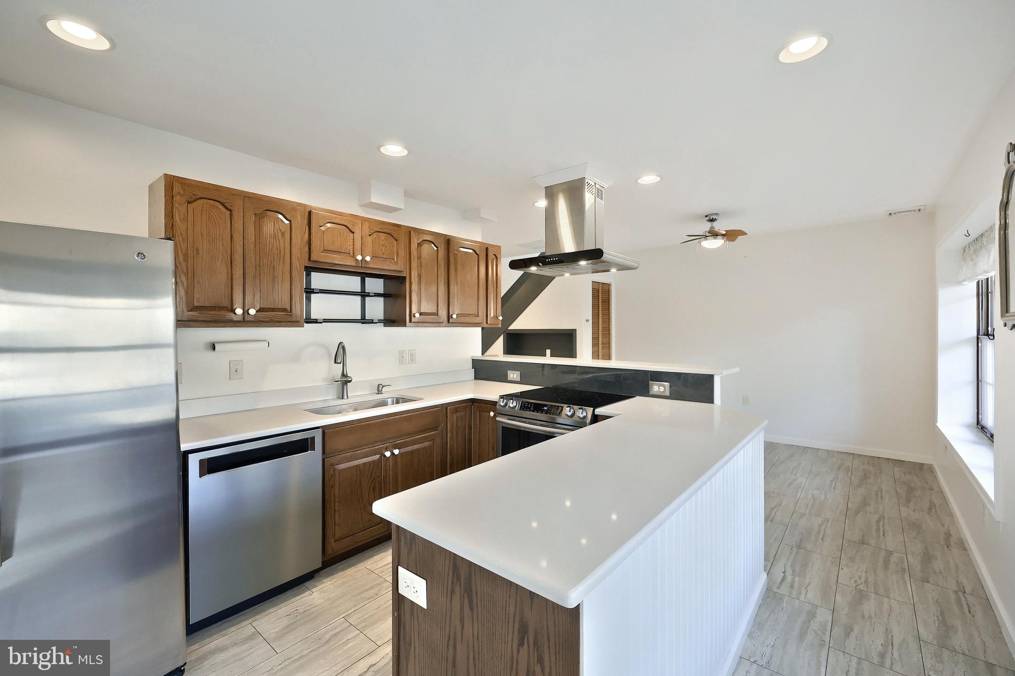 6691 Harmony Grove Road Dover, PA 17315 - Photo 31 of 66 a kitchen with stainless steel appliances a sink a stove a refrigerator and cabinets