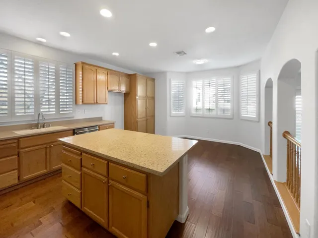 a kitchen with a wooden floor and large window