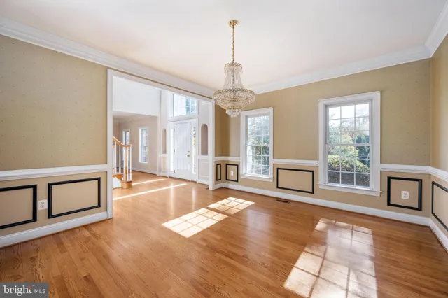 a living room with furniture a fireplace and a large window
