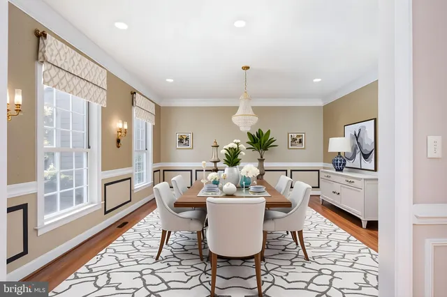 a living room with furniture a chandelier and a fireplace