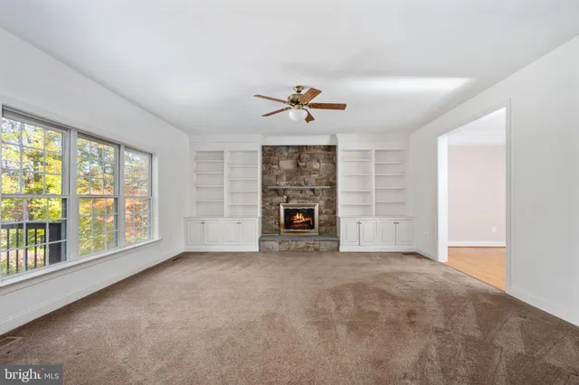 a kitchen with stainless steel appliances granite countertop a sink and cabinets with wooden floors