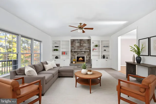 a large kitchen with granite countertop a stove a sink a refrigerator and blue cabinets with wooden floor