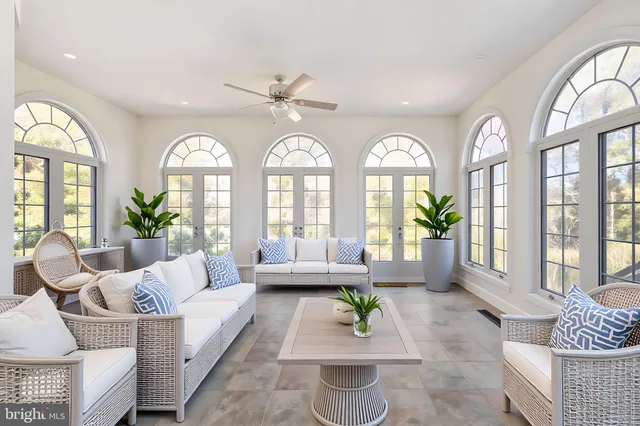 a view of a hallway to a livingroom with furniture