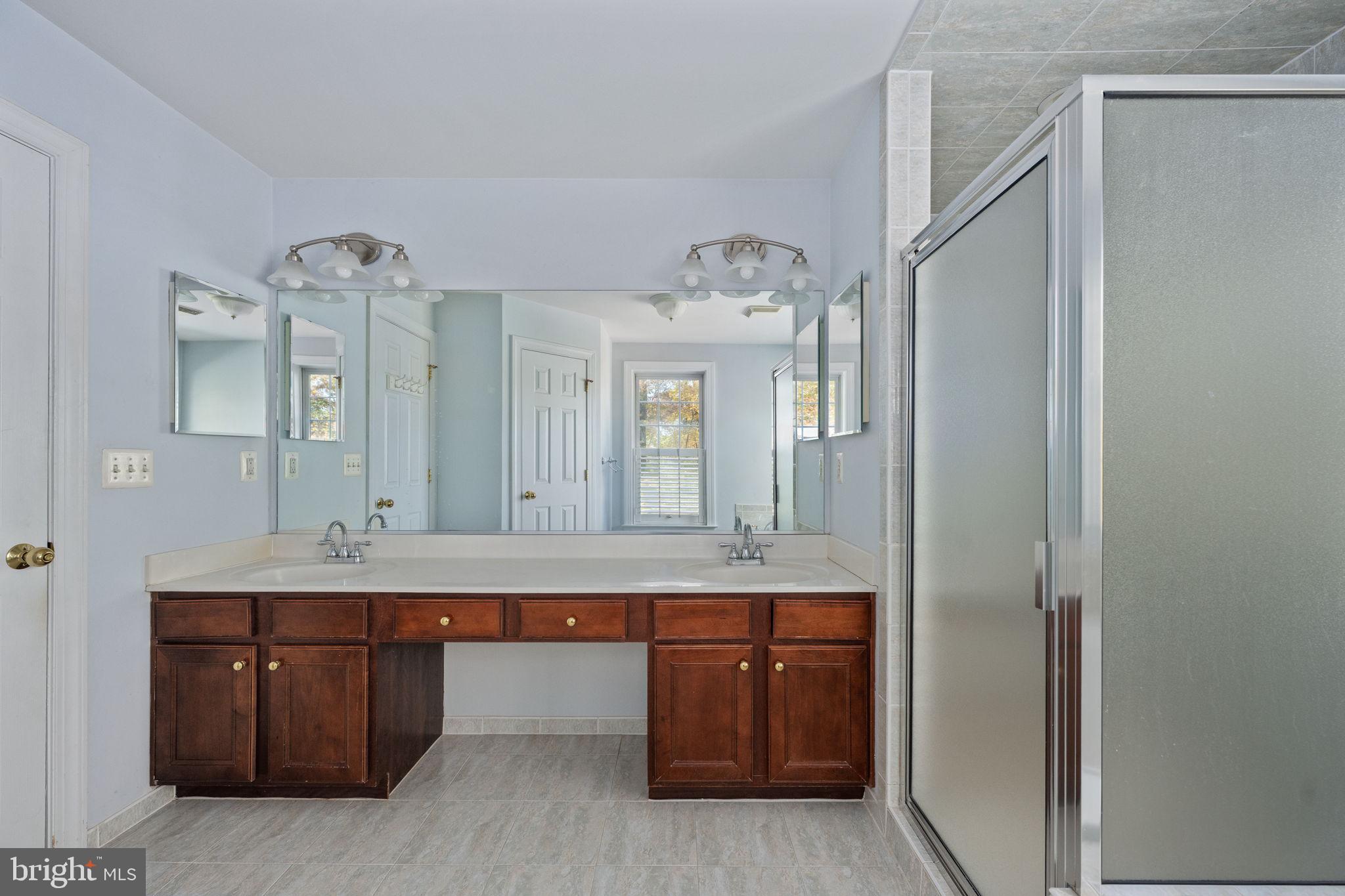 231 Kimberwick Lane Stafford, VA 22556 - Photo 44 of 78 a bathroom with a granite countertop sink a mirror and shower
