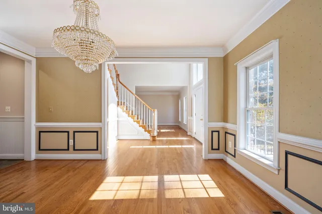 an empty room with windows and fireplace