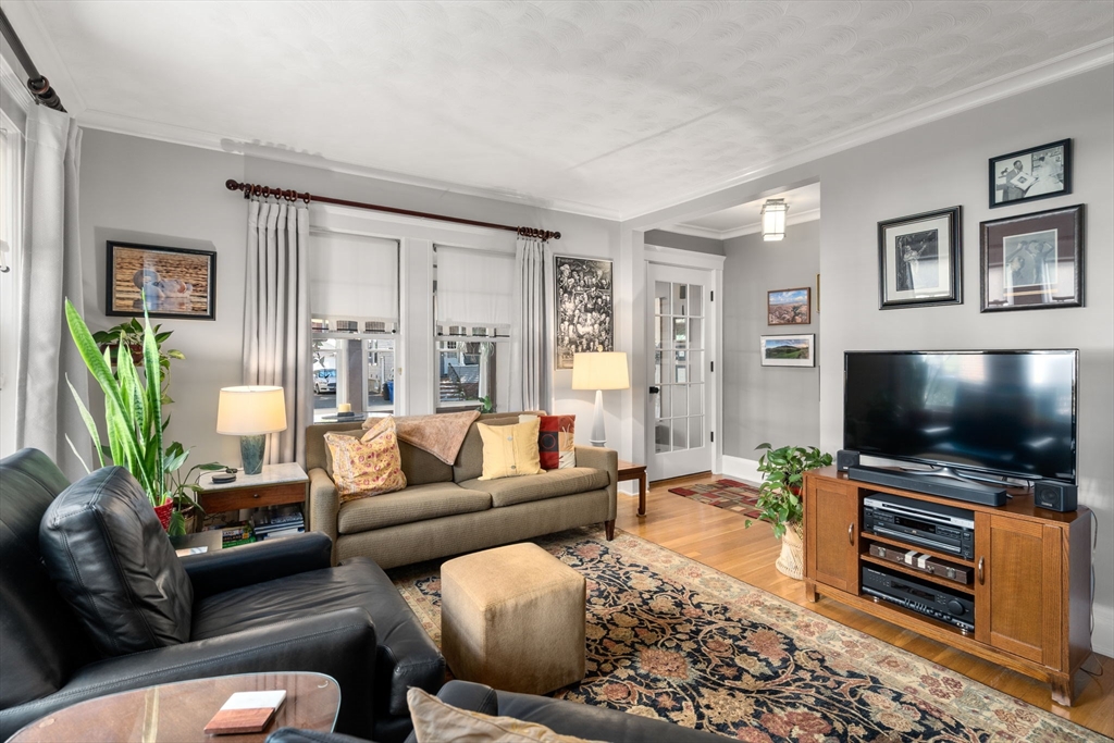 15 Berkshire Road, Unit 1 Waltham, MA 02453 - Photo 11 of 42 a living room with furniture and a flat screen tv