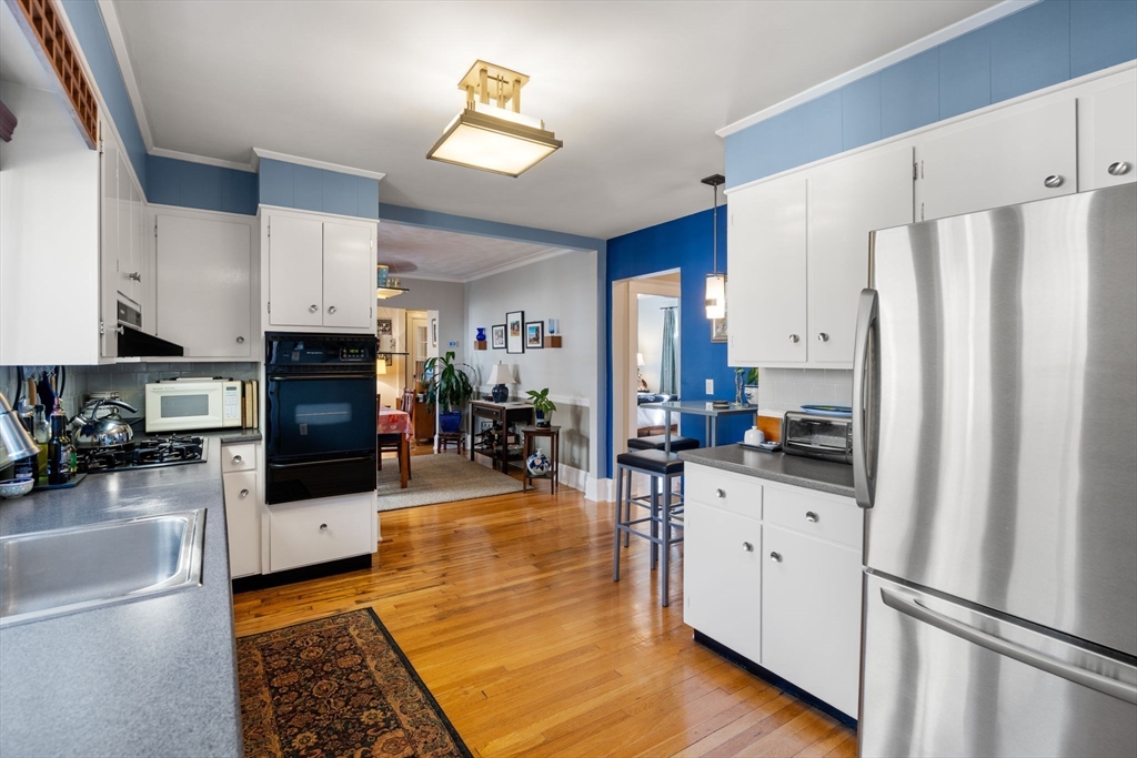 15 Berkshire Road, Unit 1 Waltham, MA 02453 - Photo 22 of 42 a kitchen with stainless steel appliances a refrigerator and a stove top oven