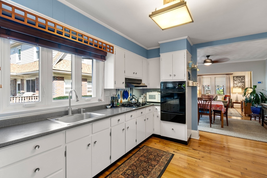 15 Berkshire Road, Unit 1 Waltham, MA 02453 - Photo 23 of 42 a kitchen with granite countertop a stove a sink and a refrigerator
