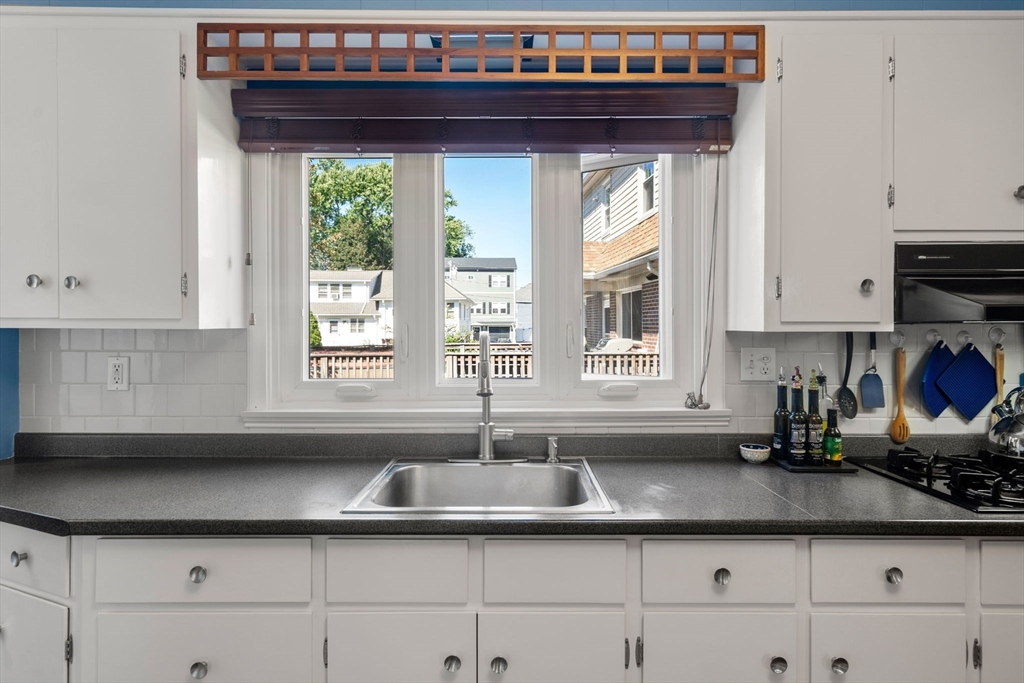 15 Berkshire Road, Unit 1 Waltham, MA 02453 - Photo 24 of 42 a kitchen with a sink and cabinets