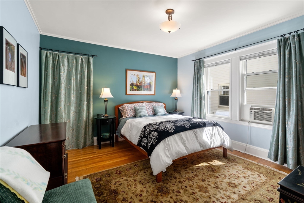 15 Berkshire Road, Unit 1 Waltham, MA 02453 - Photo 25 of 42 a bedroom with a bed lamp and a large window