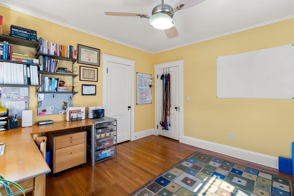 15 Berkshire Road, Unit 1 Waltham, MA 02453 - Photo 28 of 42 a bed room with a bed and a book shelf