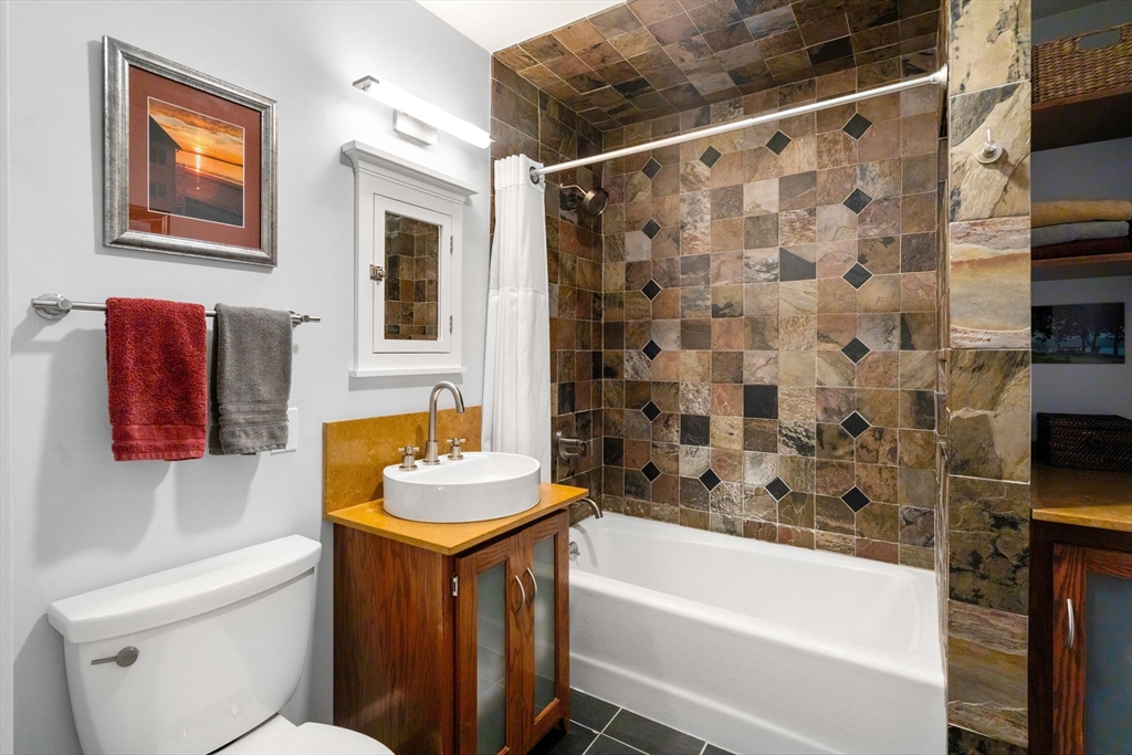 15 Berkshire Road, Unit 1 Waltham, MA 02453 - Photo 29 of 42 a bathroom with a sink toilet and shower