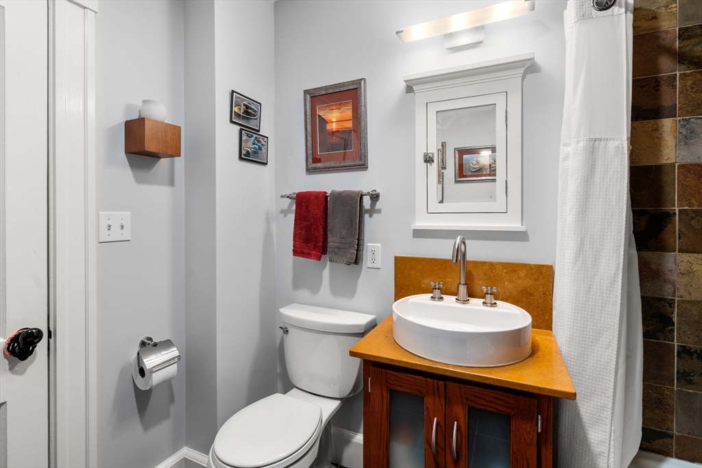 15 Berkshire Road, Unit 1 Waltham, MA 02453 - Photo 30 of 42 a bathroom with a sink toilet and mirror