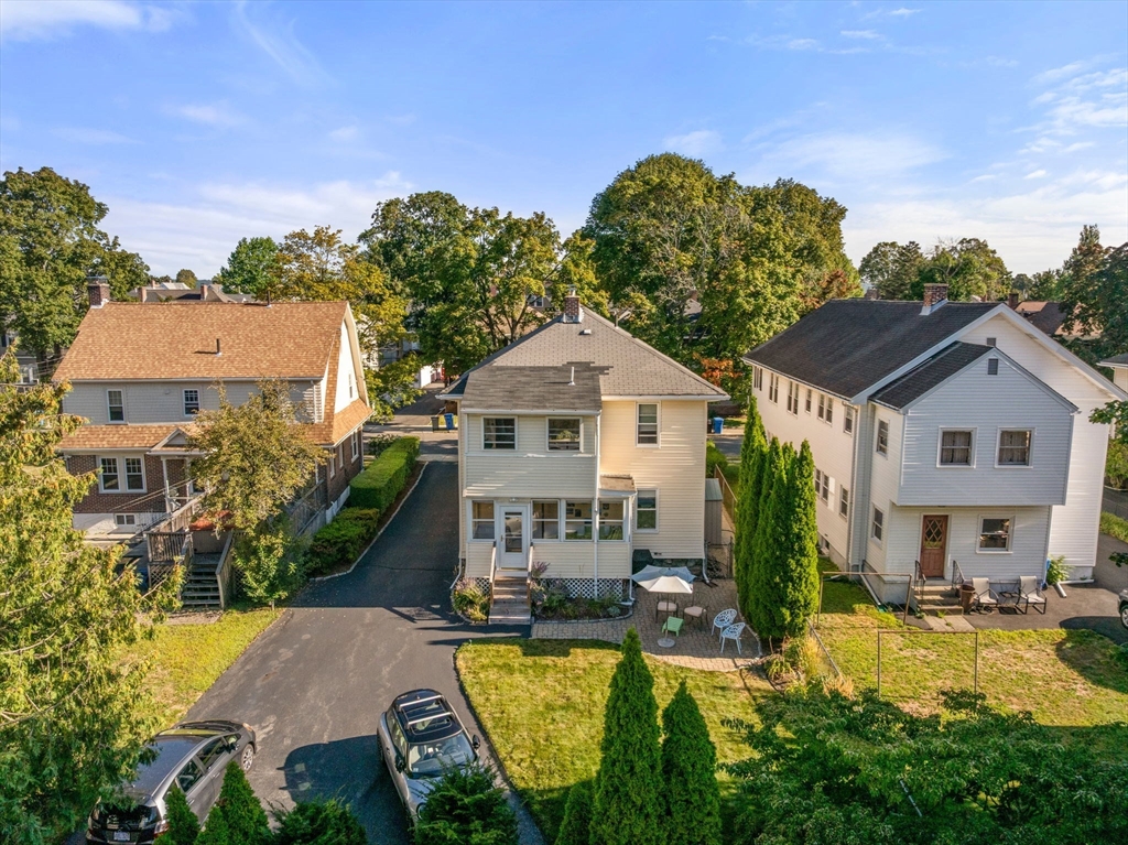 15 Berkshire Road, Unit 1 Waltham, MA 02453 - Photo 38 of 42 a aerial view of a house with swimming pool and a yard