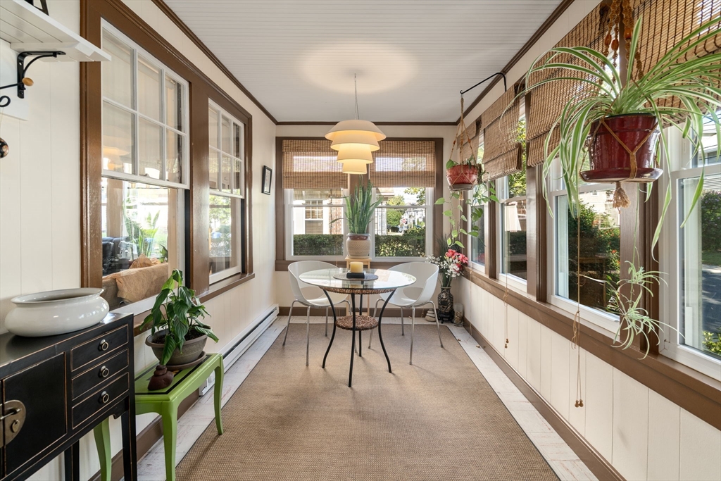 15 Berkshire Road, Unit 1 Waltham, MA 02453 - Photo 6 of 42 a view of a dining room with furniture a chandelier and wooden floor