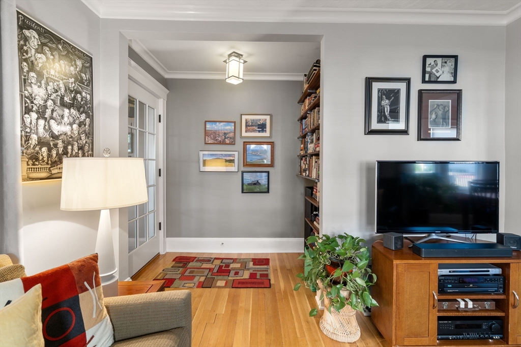 15 Berkshire Road, Unit 1 Waltham, MA 02453 - Photo 8 of 42 a living room with furniture and a flat screen tv