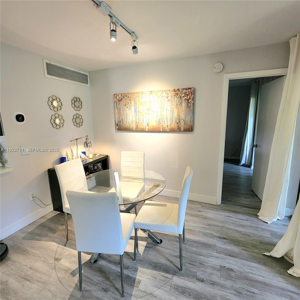 20240 Northeast 3rd Court, Unit 7 Miami, FL 33179 - Photo 2 of 8 a view of a dining room with furniture and wooden floor