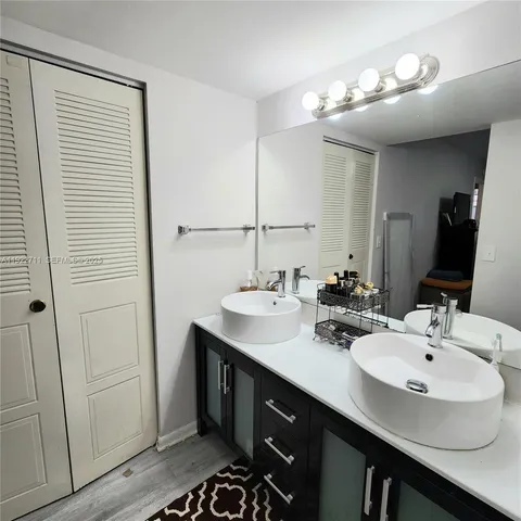 a bathroom with a sink double vanity and a mirror
