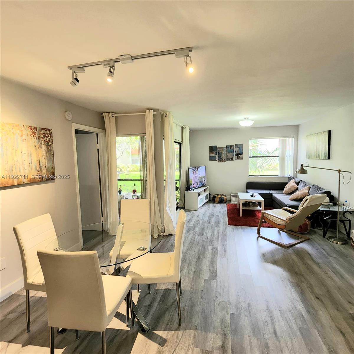 20240 Northeast 3rd Court, Unit 7 Miami, FL 33179 - Photo 8 of 8 a living room with furniture and a wooden floor
