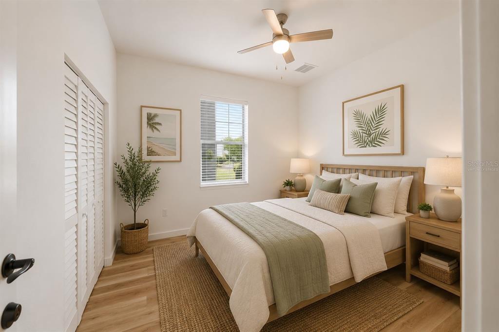 1215 Rio De Janeiro Avenue Punta Gorda, FL 33983 - Photo 14 of 65 a bedroom with a large bed and a chandelier
