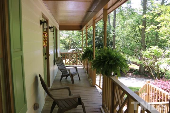 8821 Reigate Lane Raleigh, NC 27603 - Photo 3 of 23 a view of a porch with chairs and wooden floor
