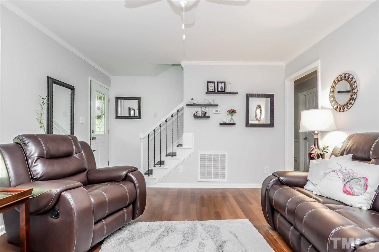 8821 Reigate Lane Raleigh, NC 27603 - Photo 5 of 23 a living room with furniture and a wooden floor