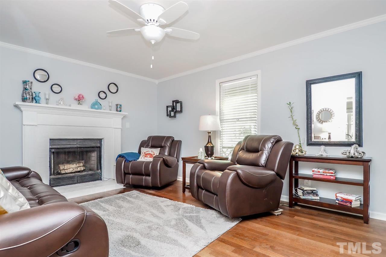 8821 Reigate Lane Raleigh, NC 27603 - Photo 8 of 23 a living room with furniture and a fireplace