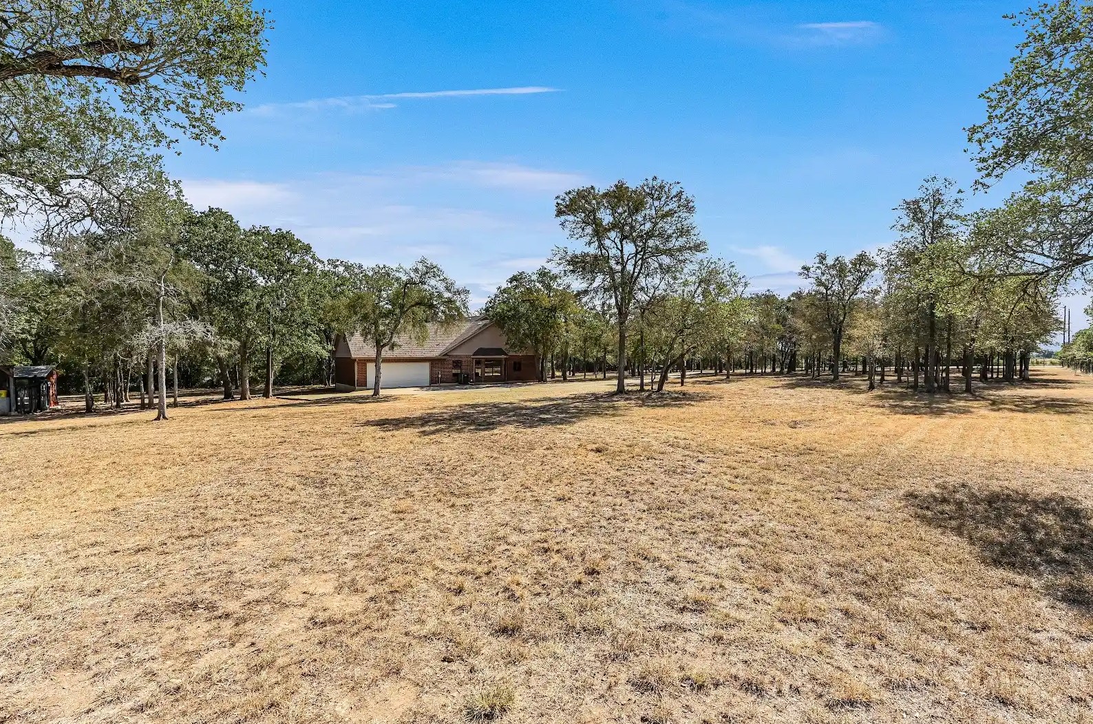 486 Westwood Road Lockhart, TX 78644 - Photo 21 of 29 View of yard featuring view of many native, shade trees and a rural view with a complete fence on all 4 sides