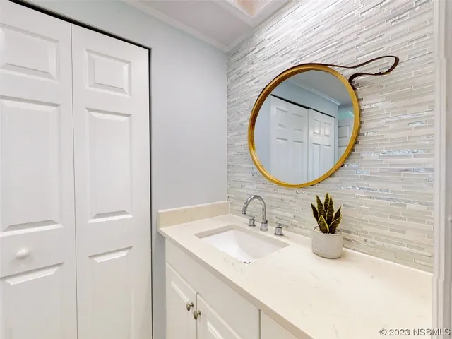 a bathroom with a sink vanity and a mirror