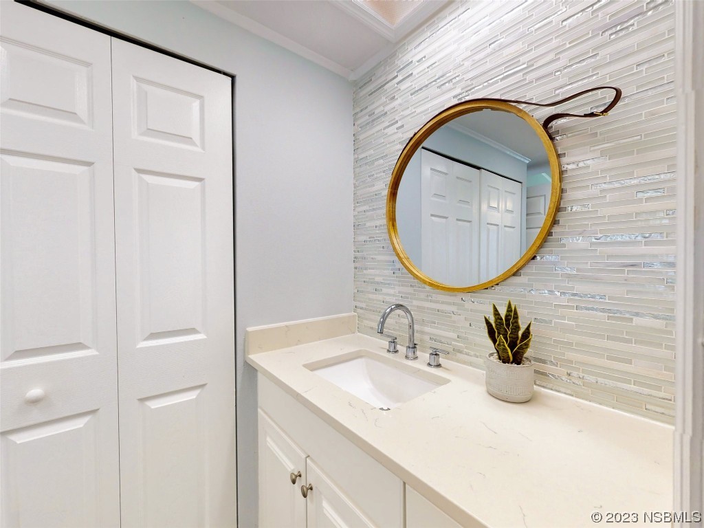 69 Sabal Cay Court, Unit 690 New Smyrna Beach, FL 32169 - Photo 15 of 30 a bathroom with a sink vanity and a mirror