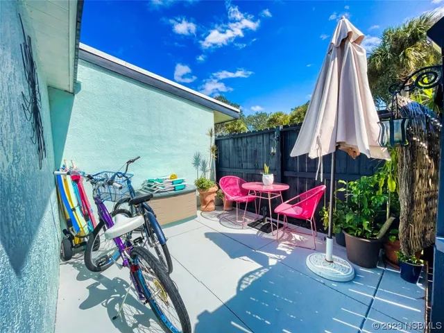 a view of a chairs and table in patio with a fire pit