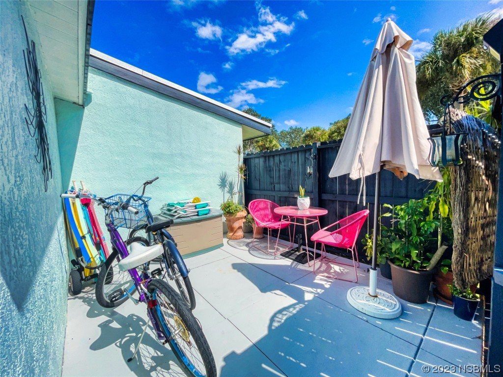 69 Sabal Cay Court, Unit 690 New Smyrna Beach, FL 32169 - Photo 19 of 30 a view of a chairs and table in patio with a fire pit