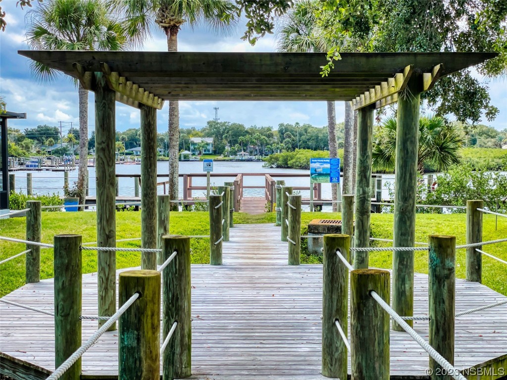 69 Sabal Cay Court, Unit 690 New Smyrna Beach, FL 32169 - Photo 20 of 30 a view of balcony with chairs and wooden fence