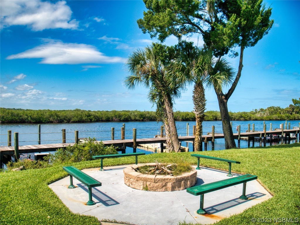 69 Sabal Cay Court, Unit 690 New Smyrna Beach, FL 32169 - Photo 24 of 30 a view of a house with swimming pool and sitting area