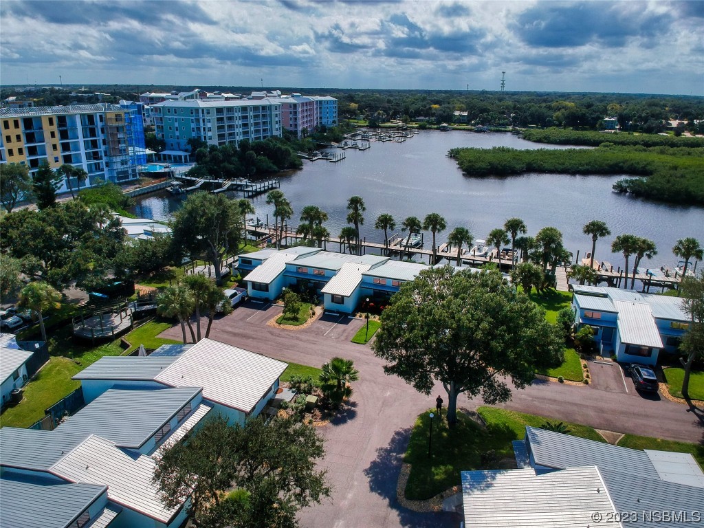 69 Sabal Cay Court, Unit 690 New Smyrna Beach, FL 32169 - Photo 26 of 30 an aerial view of a house with garden space and lake view
