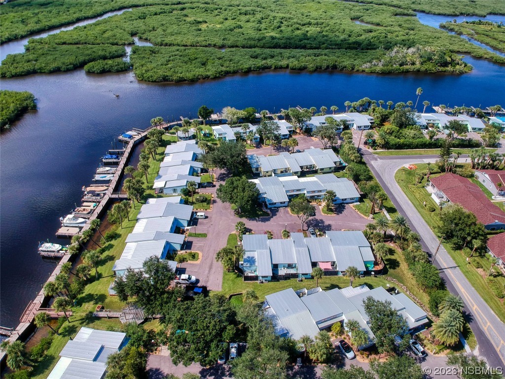 69 Sabal Cay Court, Unit 690 New Smyrna Beach, FL 32169 - Photo 27 of 30 an aerial view of a house with a yard and outdoor seating