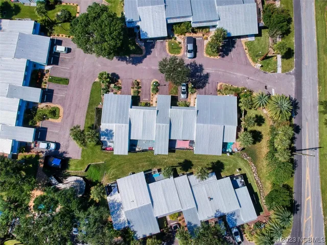 an aerial view of multiple houses with yard