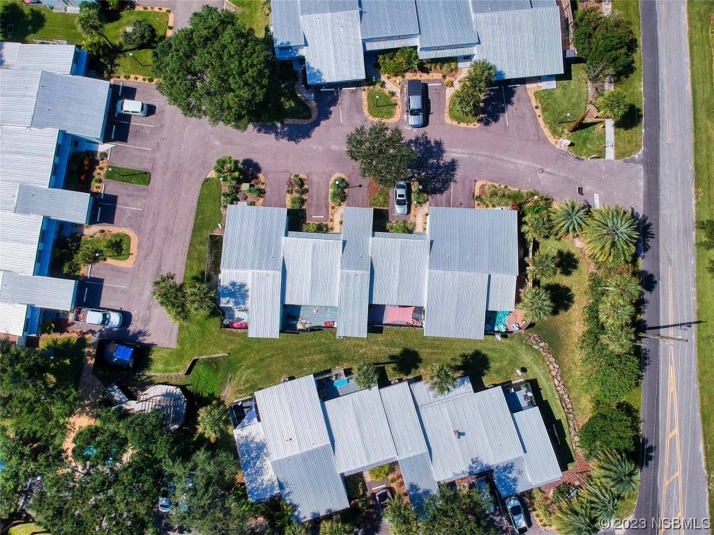69 Sabal Cay Court, Unit 690 New Smyrna Beach, FL 32169 - Photo 28 of 30 an aerial view of multiple houses with yard