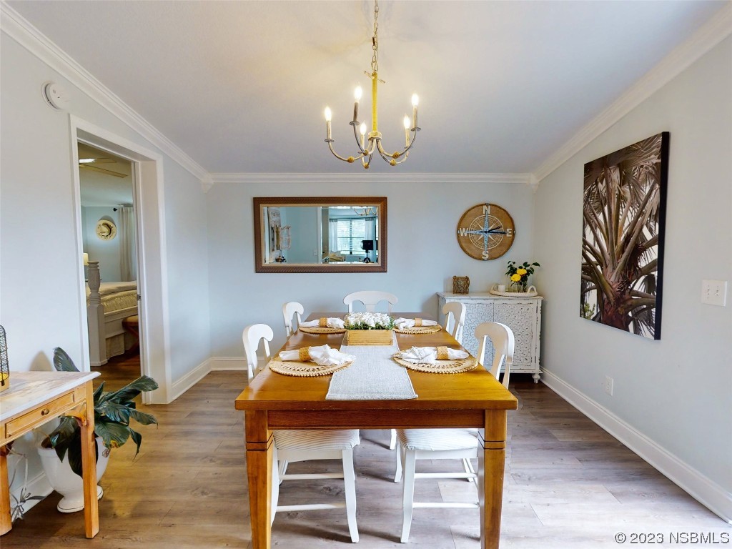 69 Sabal Cay Court, Unit 690 New Smyrna Beach, FL 32169 - Photo 7 of 30 a view of a dining room with furniture and wooden floor