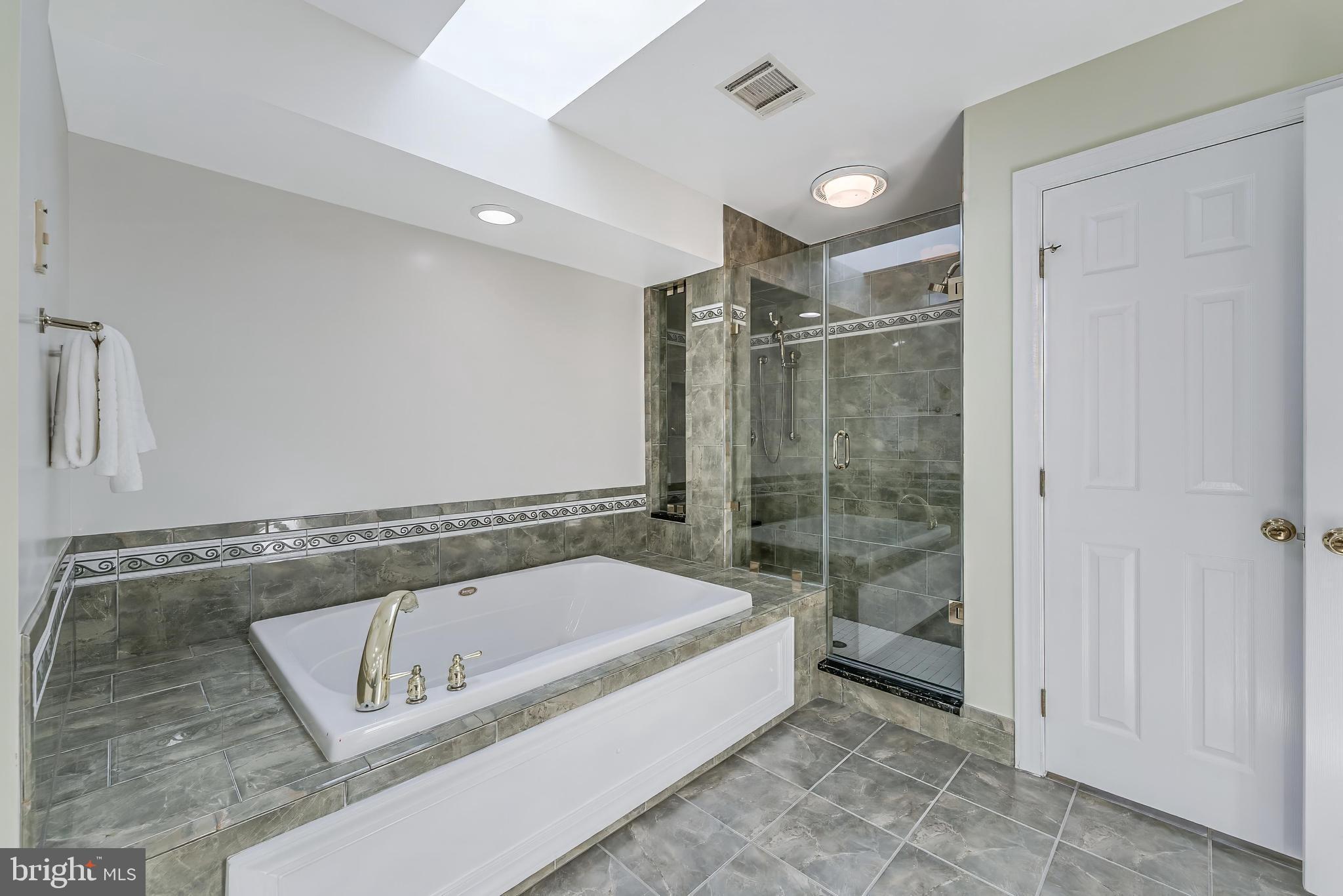 5501 Ashleigh Road Fairfax, VA 22030 - Photo 48 of 77 a bathroom with a tub and a shower