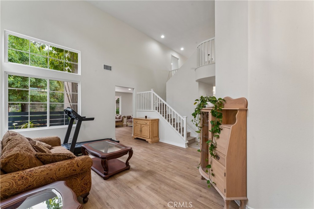 26023 Salinger Lane Stevenson Ranch, CA 91381 - Photo 3 of 35 Spacious living room featuring impressive high ceilings, abundant natural light, and a modern open-concept layout.