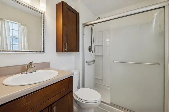 a bathroom with a sink toilet and shower