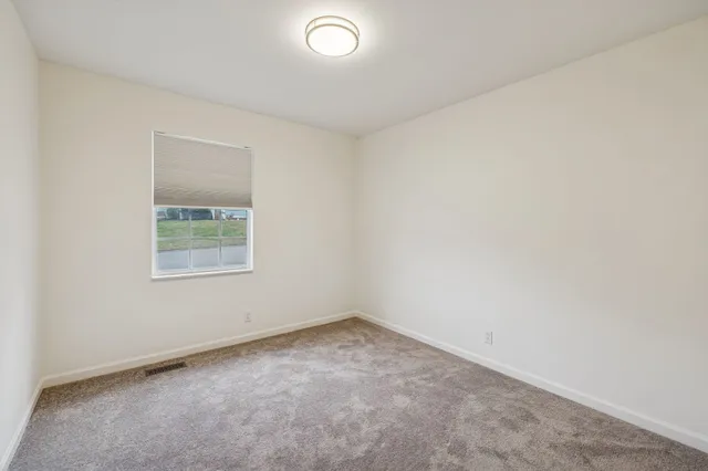 an empty room with closet area