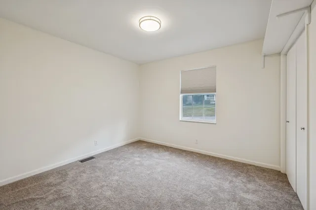 an empty room with a empty space and window