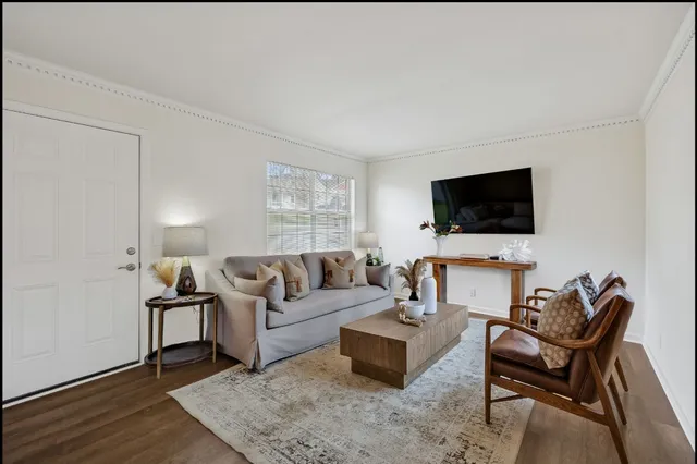 a living room with furniture and a flat screen tv